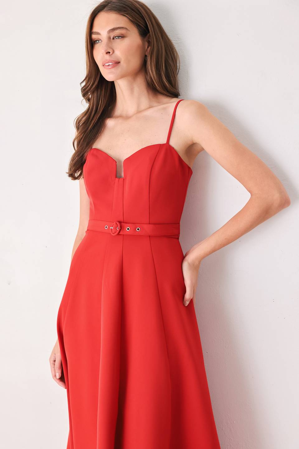 Woman wearing a red spaghetti strap midi dress with a sweetheart neckline and matching thin waist belt | FREEMARKET