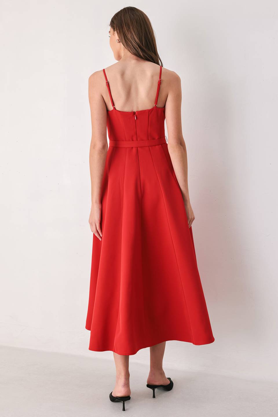 Woman wearing a red spaghetti strap midi dress with a sweetheart neckline and matching thin waist belt | FREEMARKET