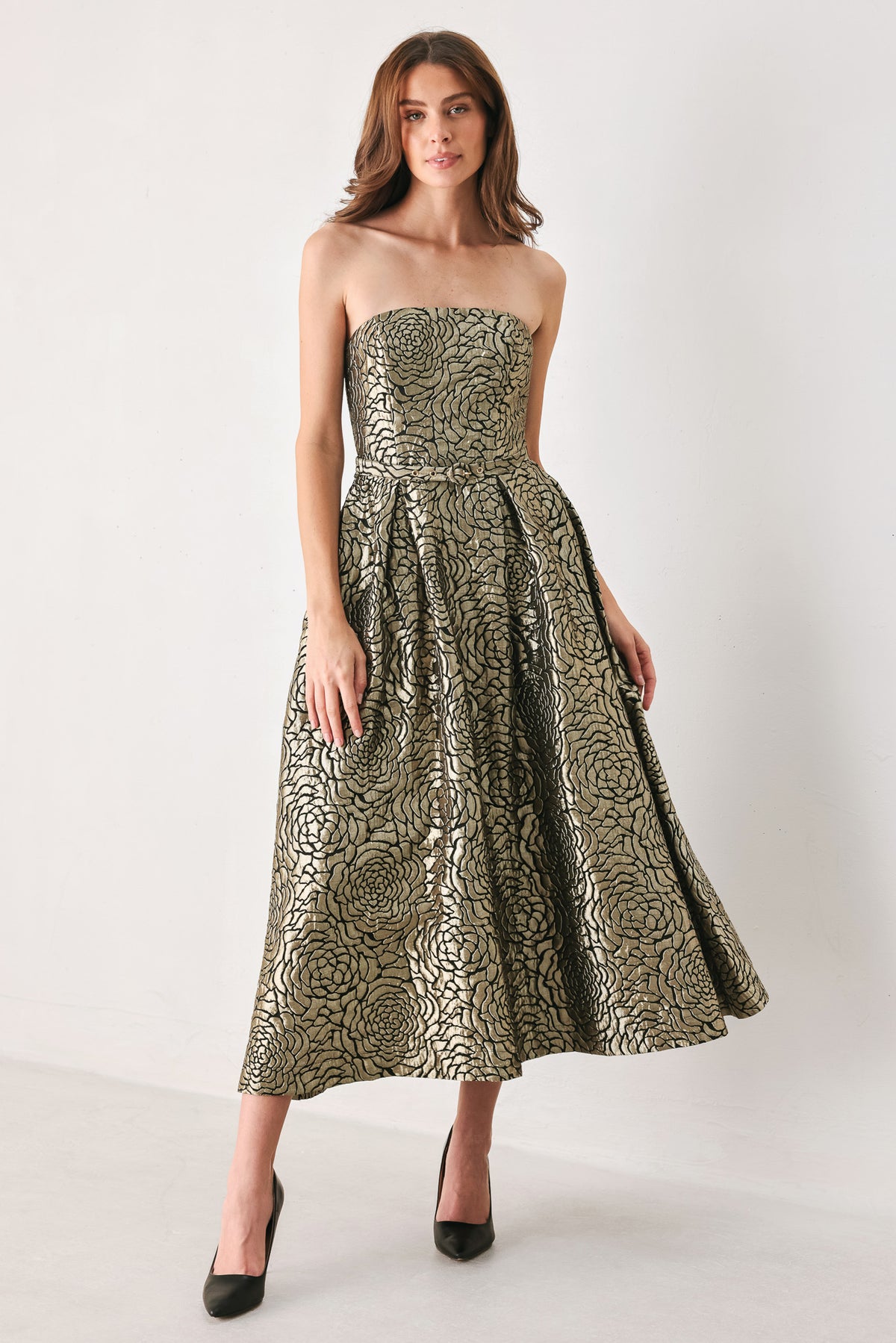 A woman models a strapless midi dress with a black and metallic gold floral pattern | FREEMARKET