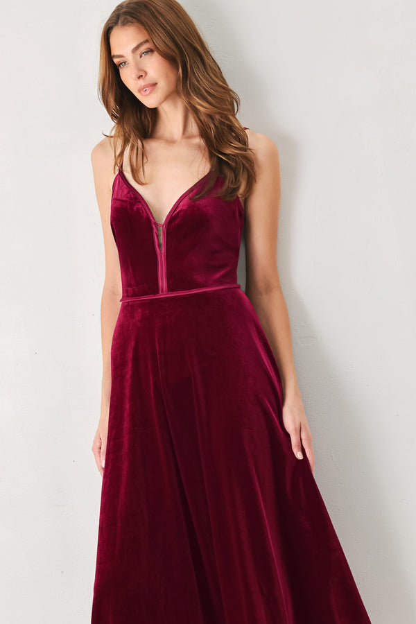 Woman wearing a sleeveless red burgundy velvet midi dress with a slight plunge | FREEMARKET