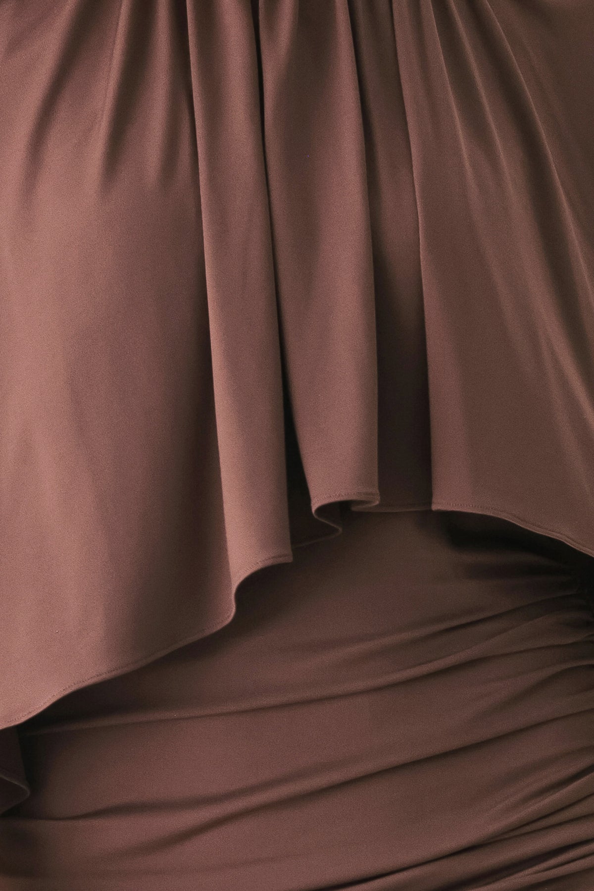 A woman models a brown mauve draped midi dress with a high neck, wide cape sleeves, ruched detailing at the waist, and a side slit | FREEMARKET