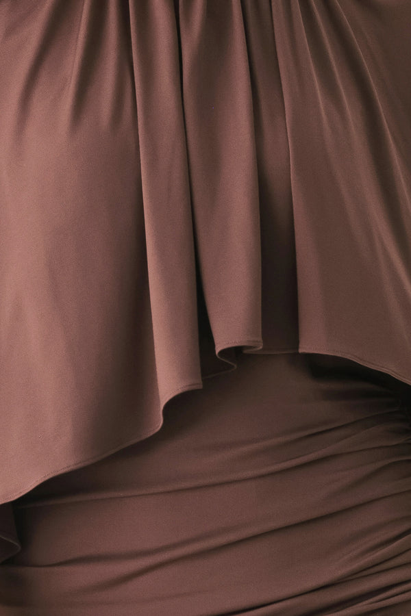 A woman models a brown mauve draped midi dress with a high neck, wide cape sleeves, ruched detailing at the waist, and a side slit | FREEMARKET