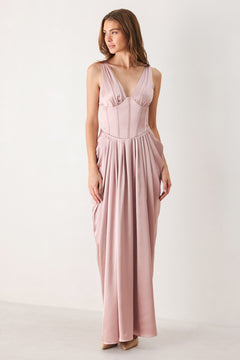 Woman wearing a pink satin sleeveless gown with structured boning on around the waist and pleated skirt | FREEMARKET