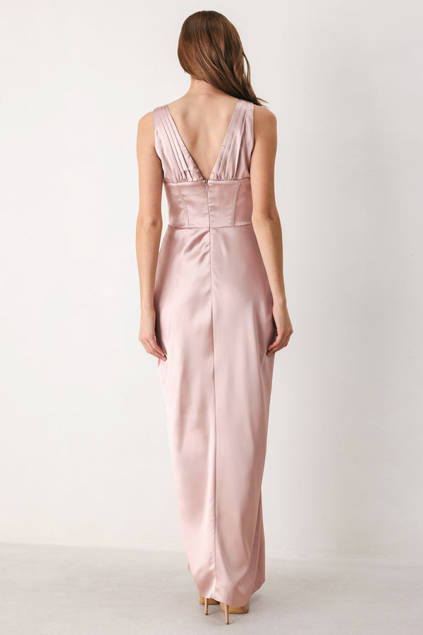 Woman wearing a pink satin sleeveless gown with structured boning on around the waist and pleated skirt | FREEMARKET