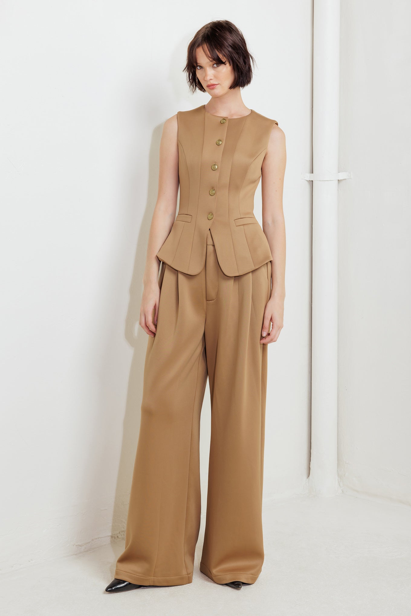 A solid woven vest featuring round neckline, sleeveless, front button down and pockets.