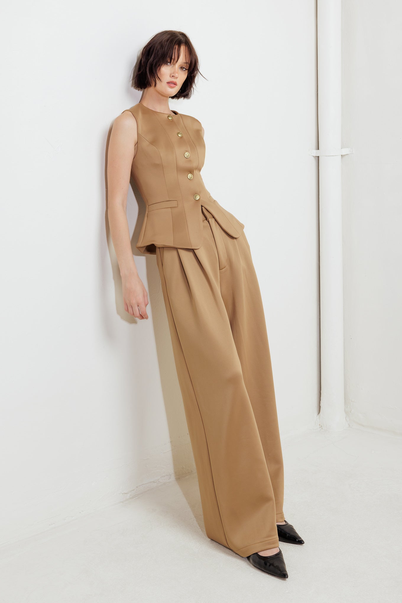 A solid woven vest featuring round neckline, sleeveless, front button down and pockets.