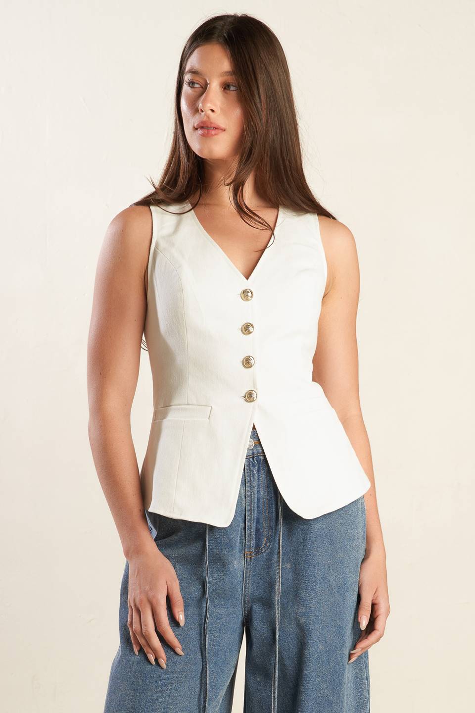 A solid white woven vest featuring V neckline, sleeveless and button down.