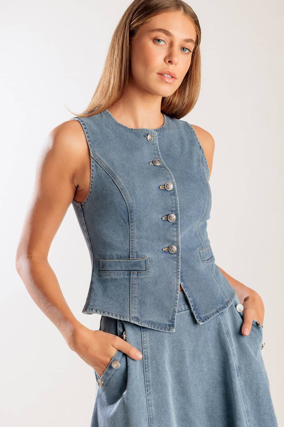 A washed denim vest with round neckline, sleeveless and front button down