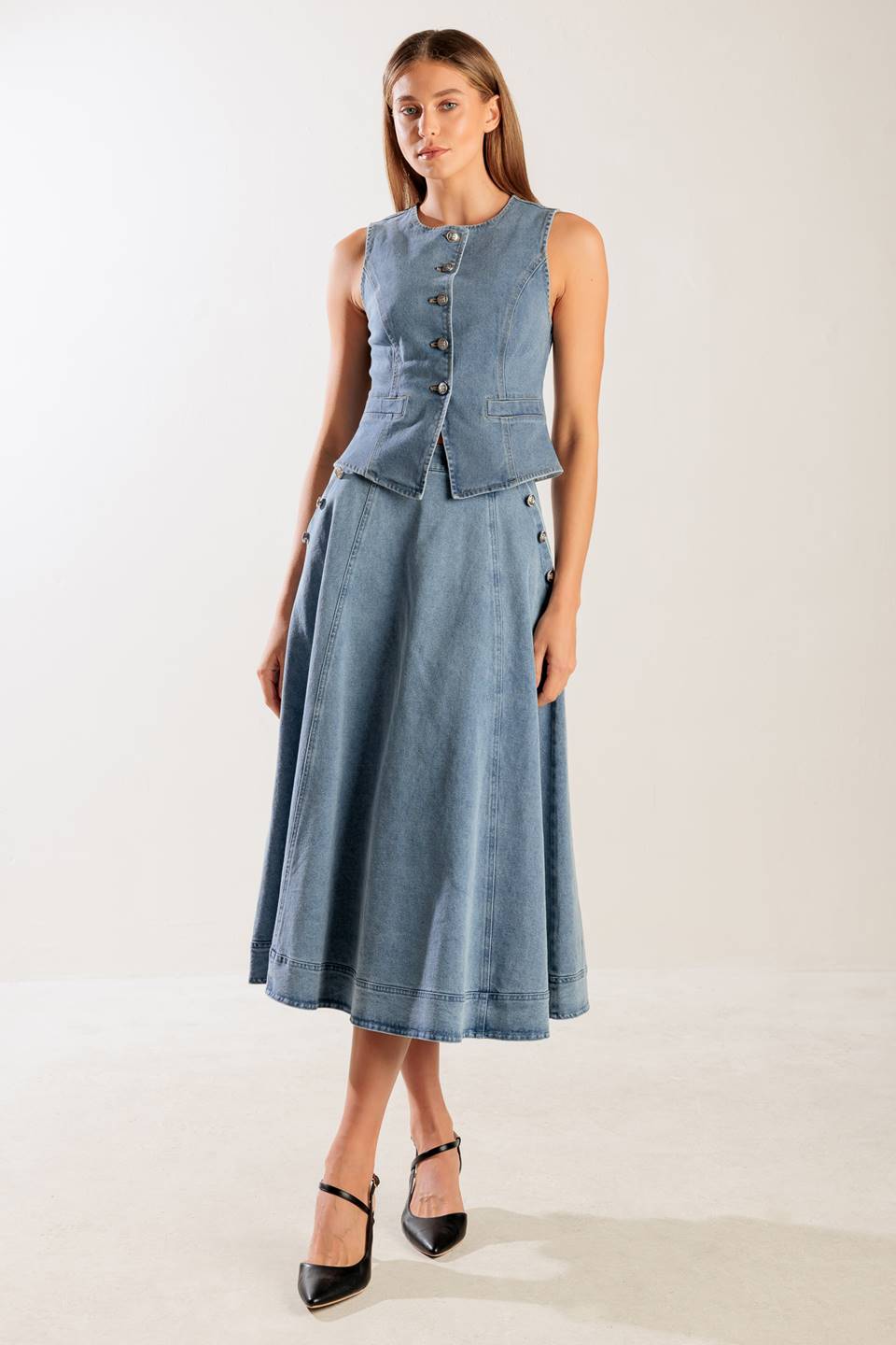 A washed denim vest with round neckline, sleeveless and front button down