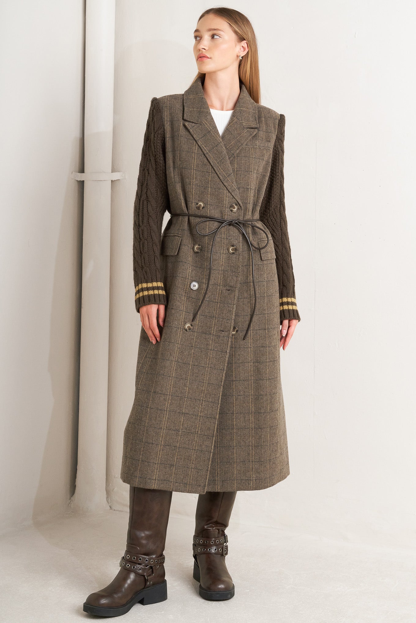 A woven midi coat featuring double breast front button closure, contrasting belt and sweater sleeve