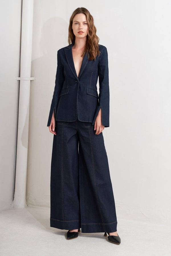 A denim blazer with single button closure and slit at sleeve