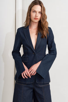A denim blazer with single button closure and slit at sleeve