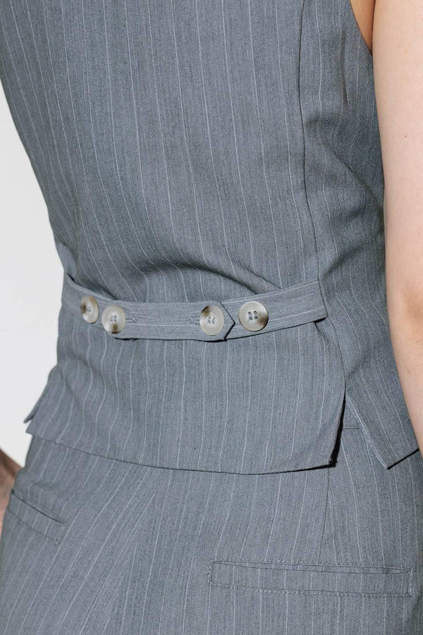 A grey striped woven vest with front button down.