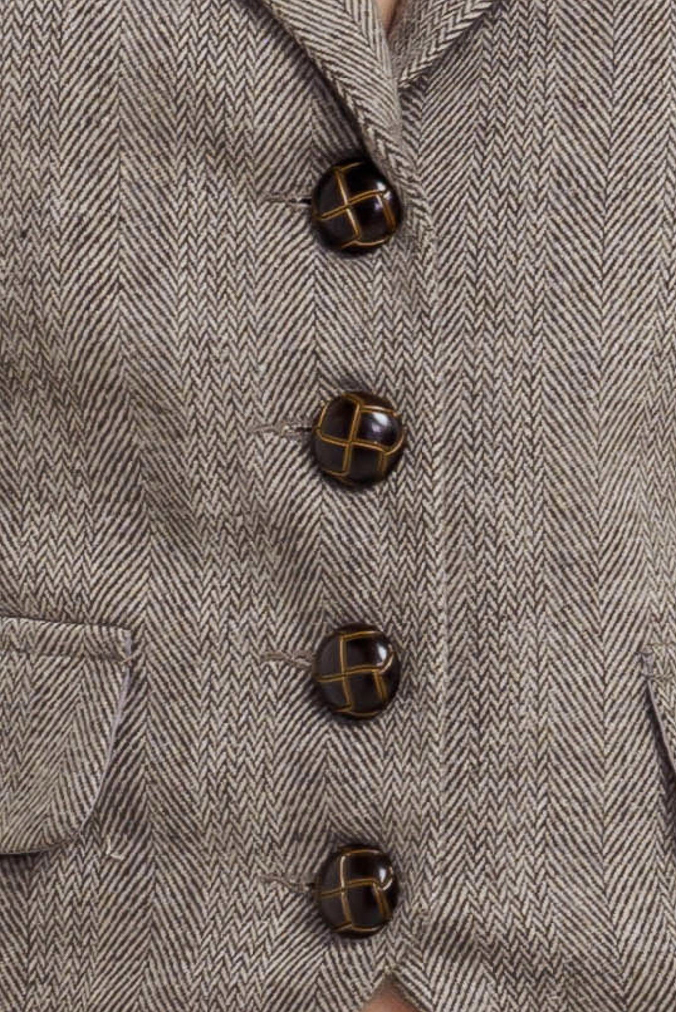 A woven vest featuring collar, sleeveless, and front button closure.