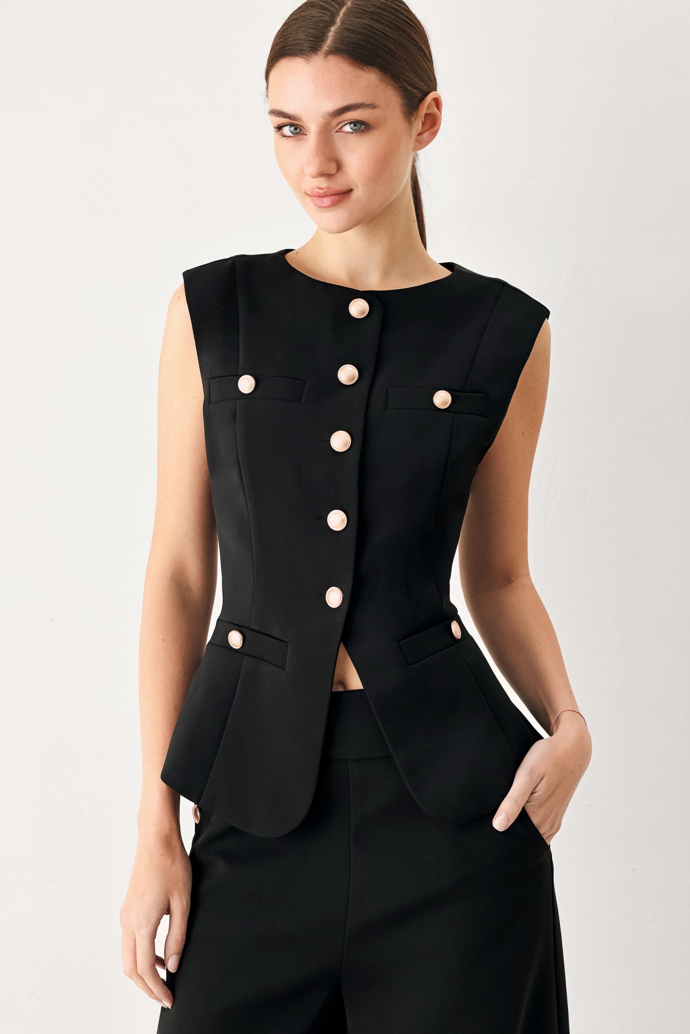 Woman wearing a black sleeveless blazer vest with gold buttons | FREEMARKET
