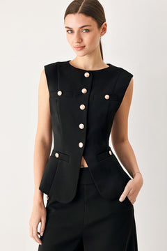 Woman wearing a black sleeveless blazer vest with gold buttons | FREEMARKET