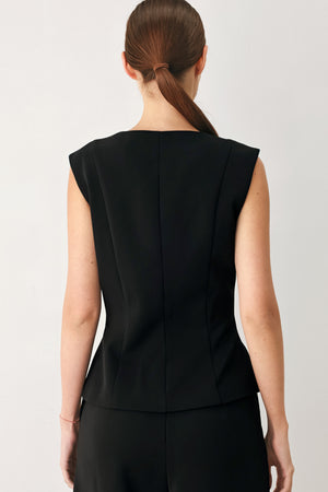 Woman wearing a black sleeveless blazer vest with gold buttons | FREEMARKET