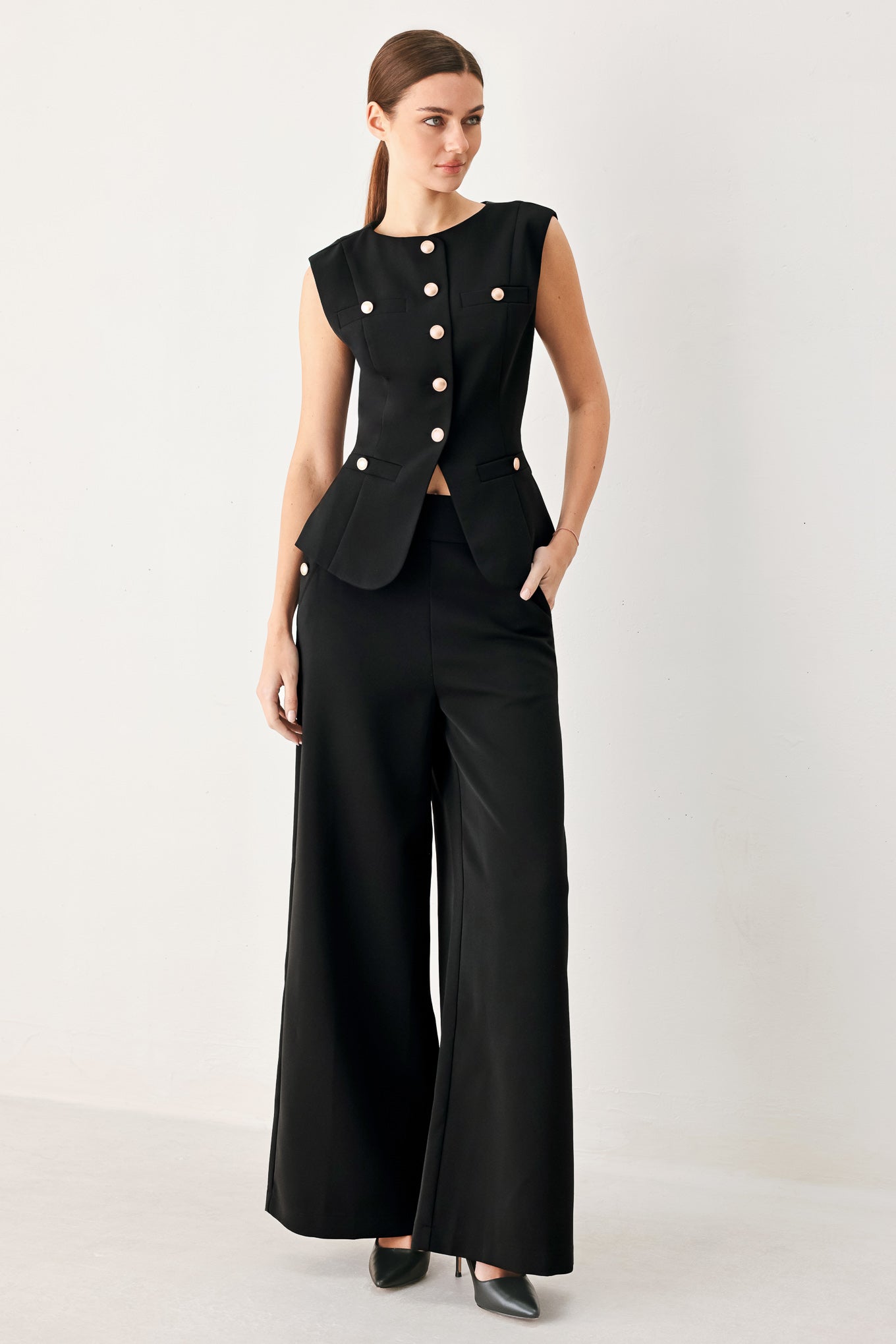 Woman wearing a black sleeveless blazer vest with gold buttons | FREEMARKET