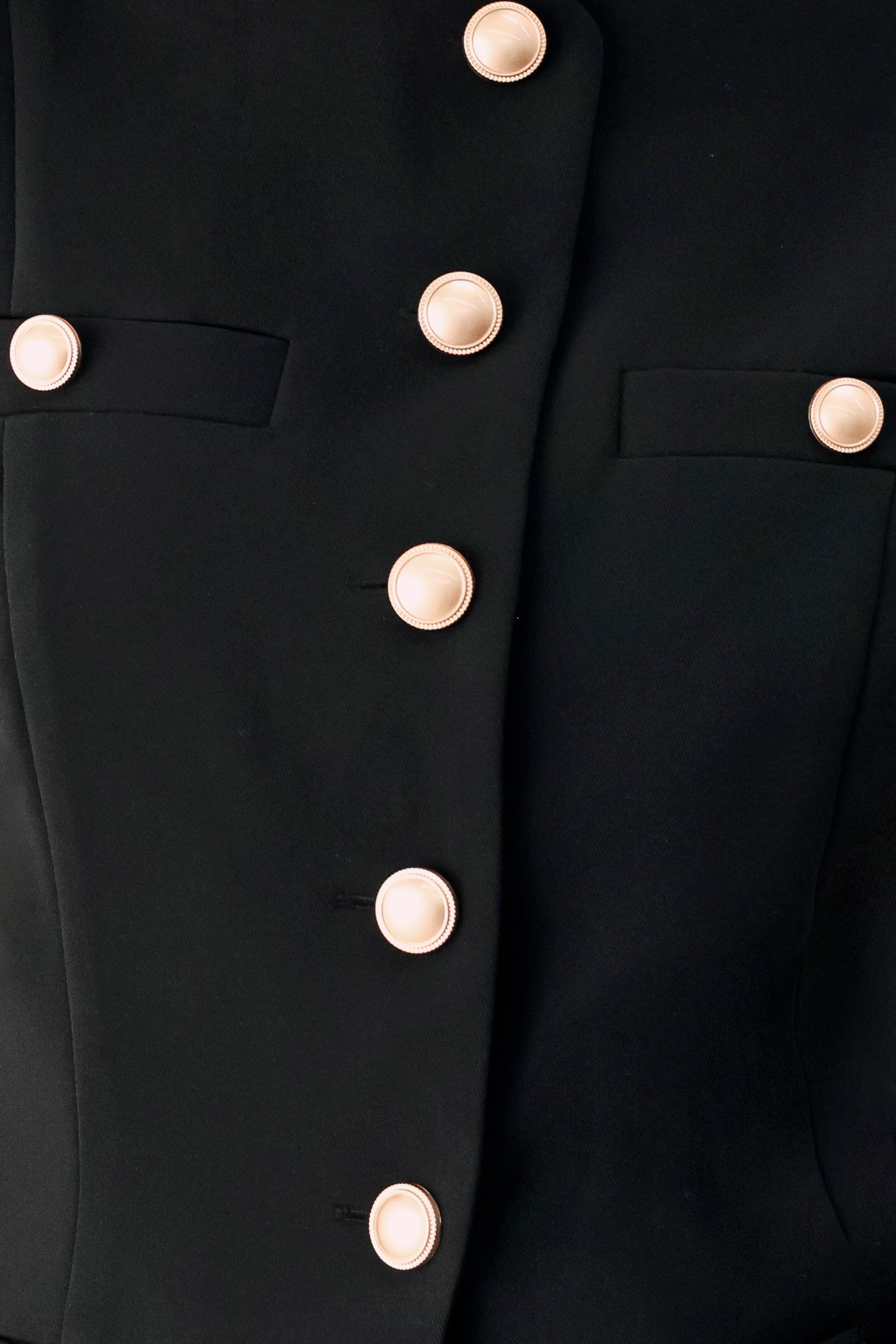Woman wearing a black sleeveless blazer vest with gold buttons | FREEMARKET