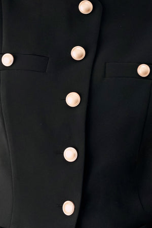Woman wearing a black sleeveless blazer vest with gold buttons | FREEMARKET