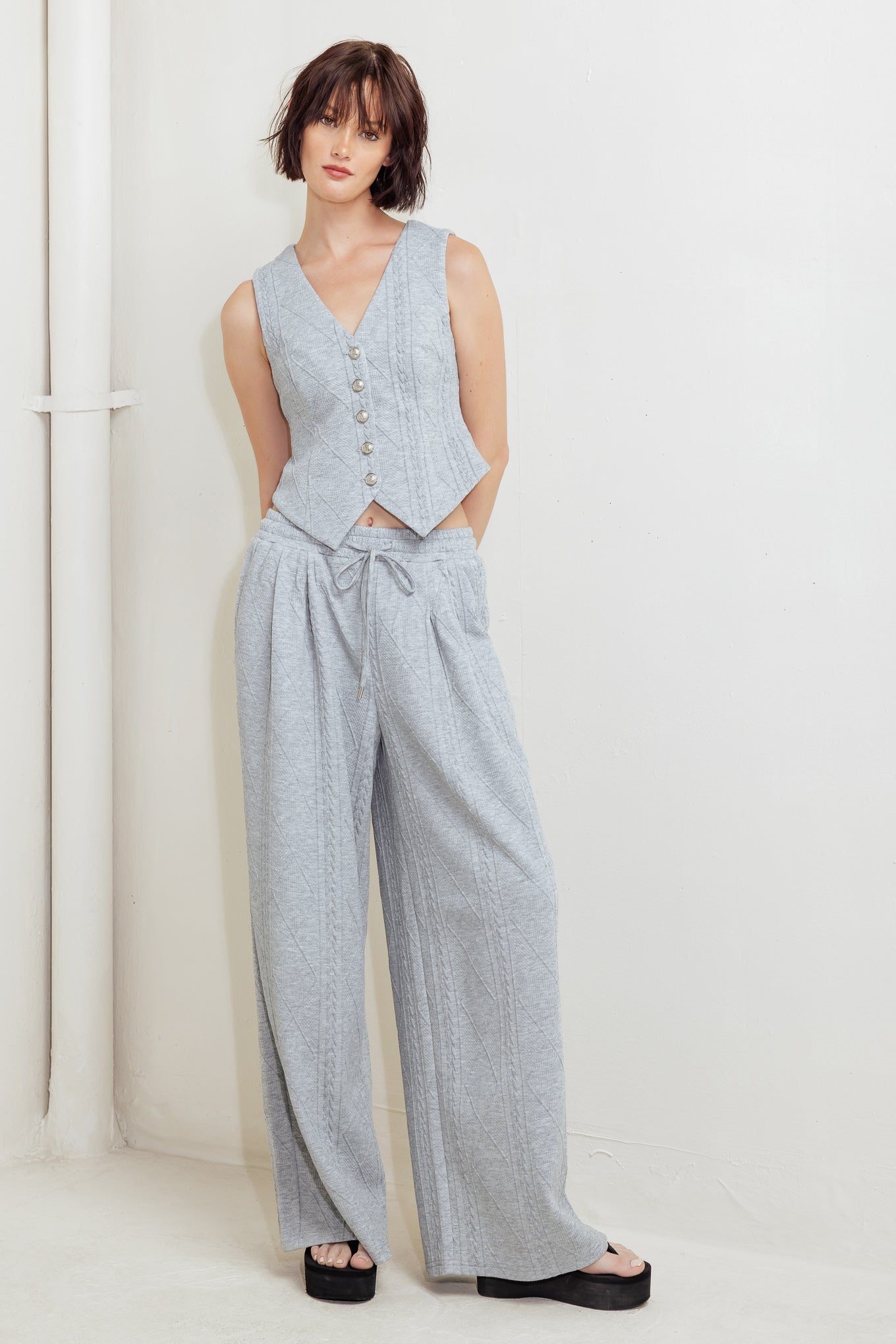 A knit cut/sew vest with front closure.