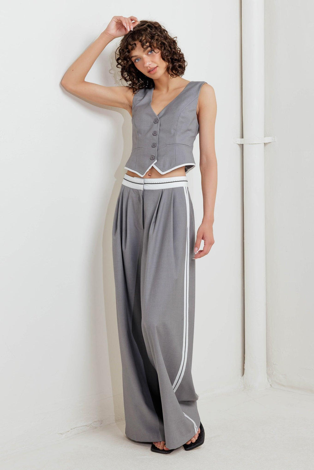A solid woven vest with front button down closure.
