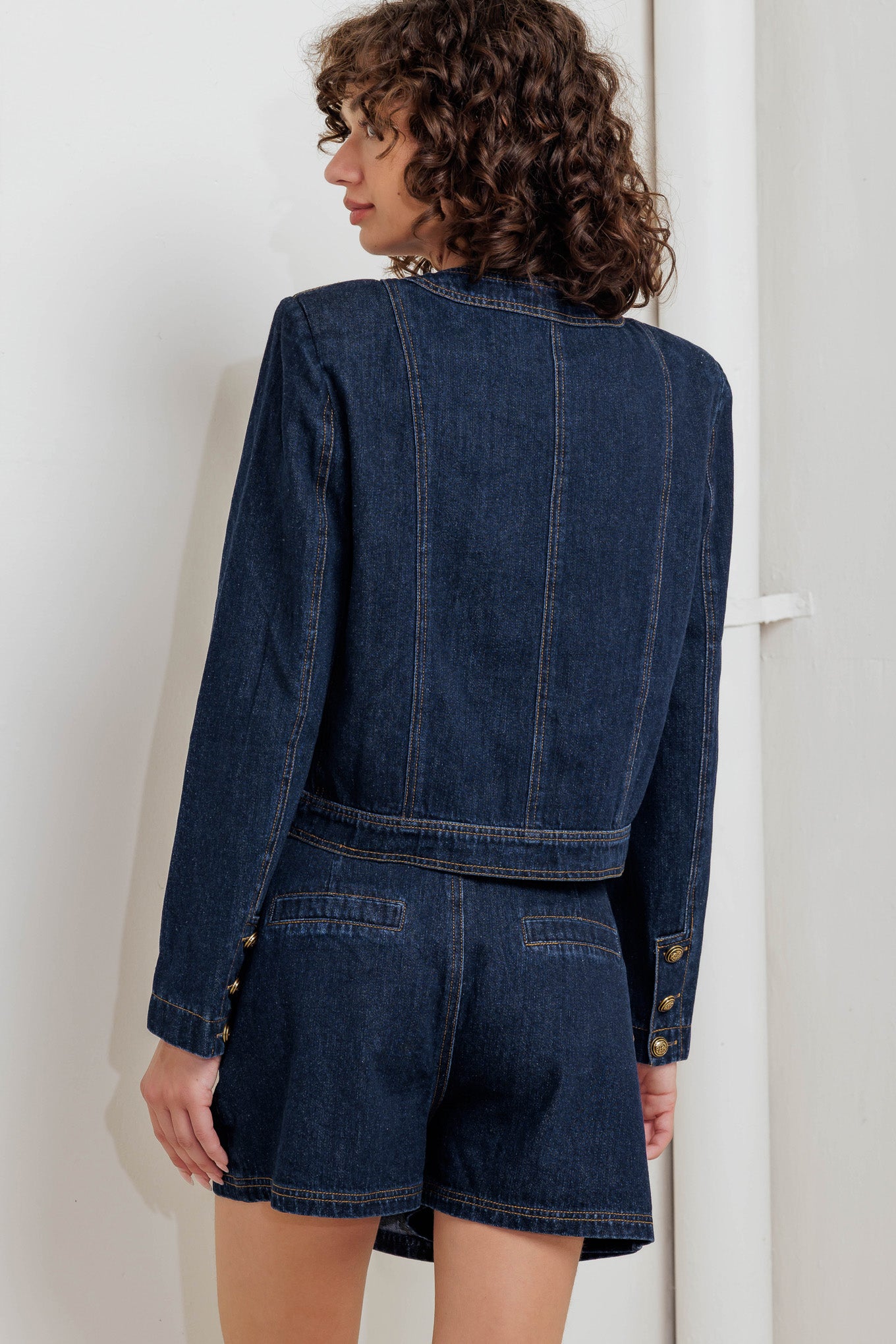 A washed denim jacket with round neck, button down and pockets