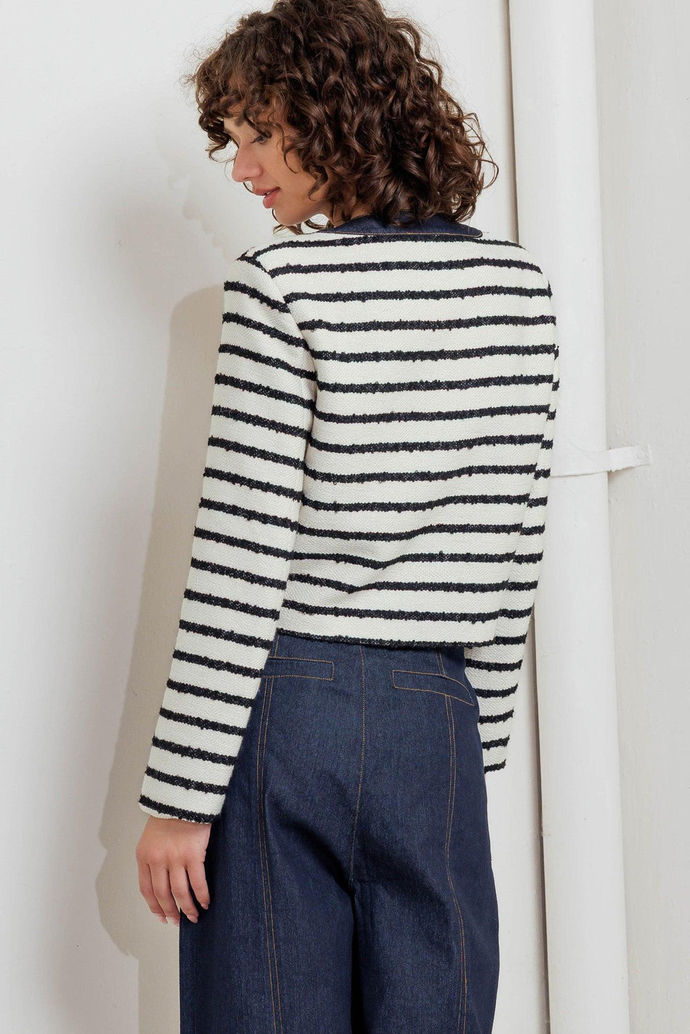 A textured striped woven crop jacket featuring round neckline, long sleeve and front button down. 