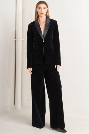 A bonded woven velvet blazer with satin collar and front single button closure.