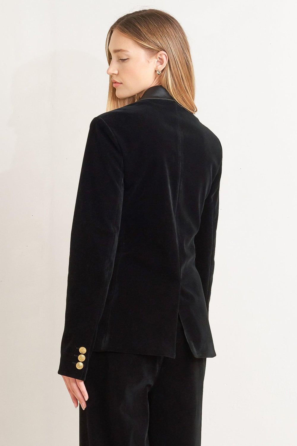 A bonded woven velvet blazer with satin collar and front single button closure.