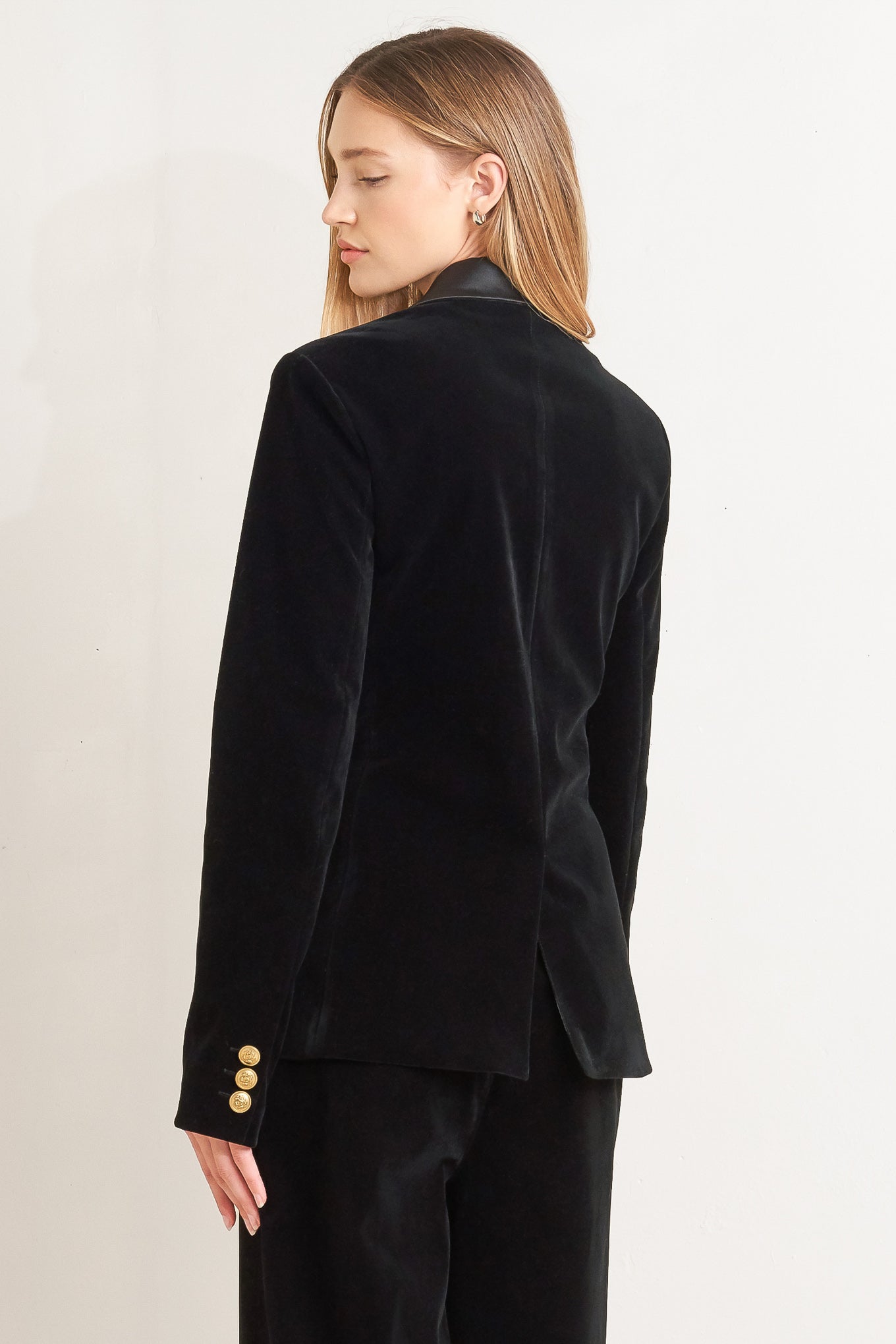 A bonded woven velvet blazer with satin collar and front single button closure.