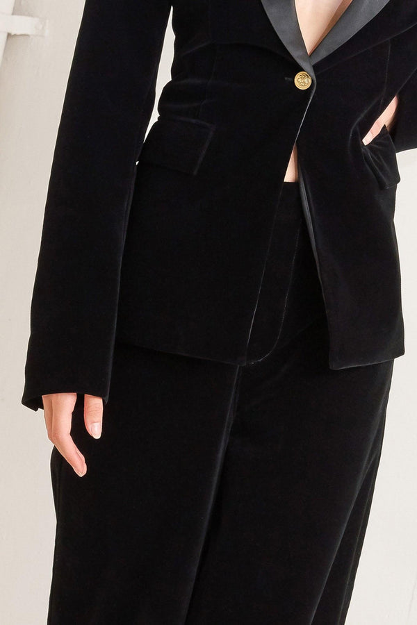 A bonded woven velvet blazer with satin collar and front single button closure.