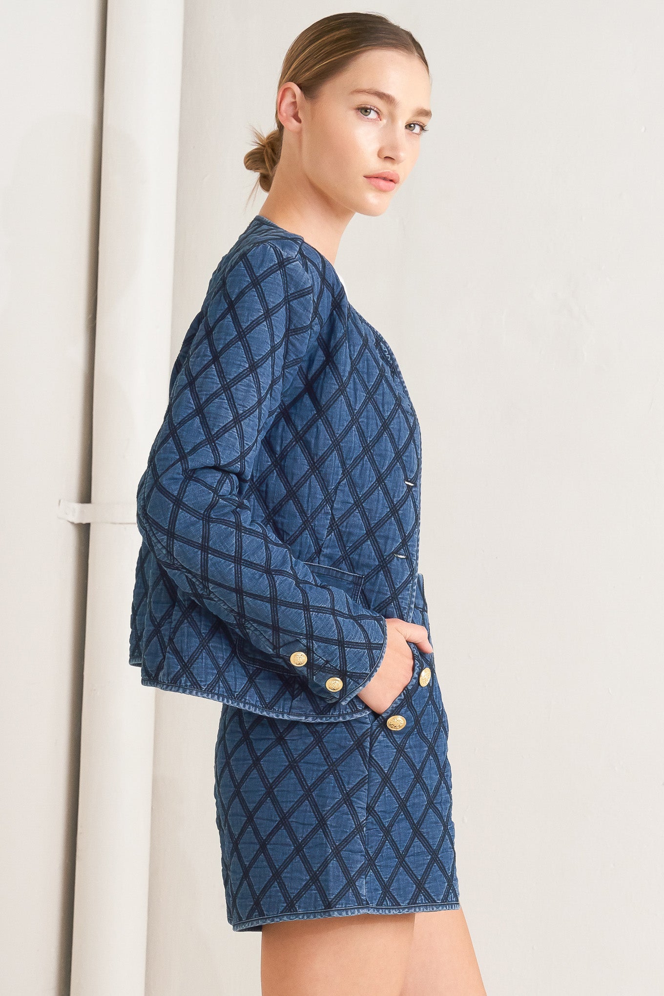 A quilted woven jacket featuring round neckline, long sleeve and front button down.