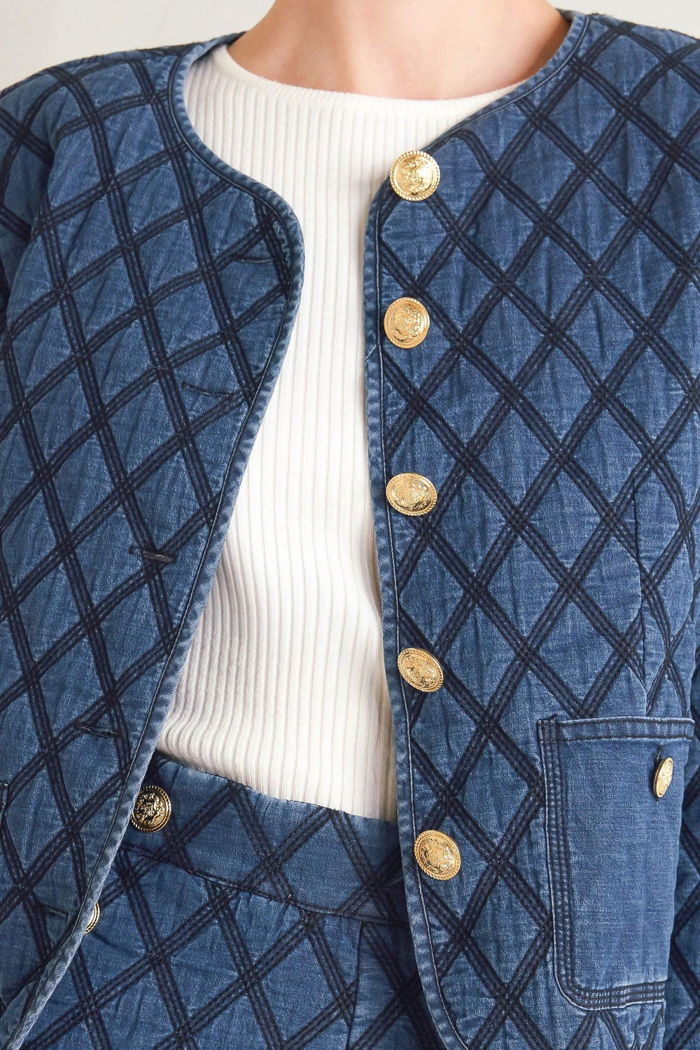 A quilted woven jacket featuring round neckline, long sleeve and front button down.