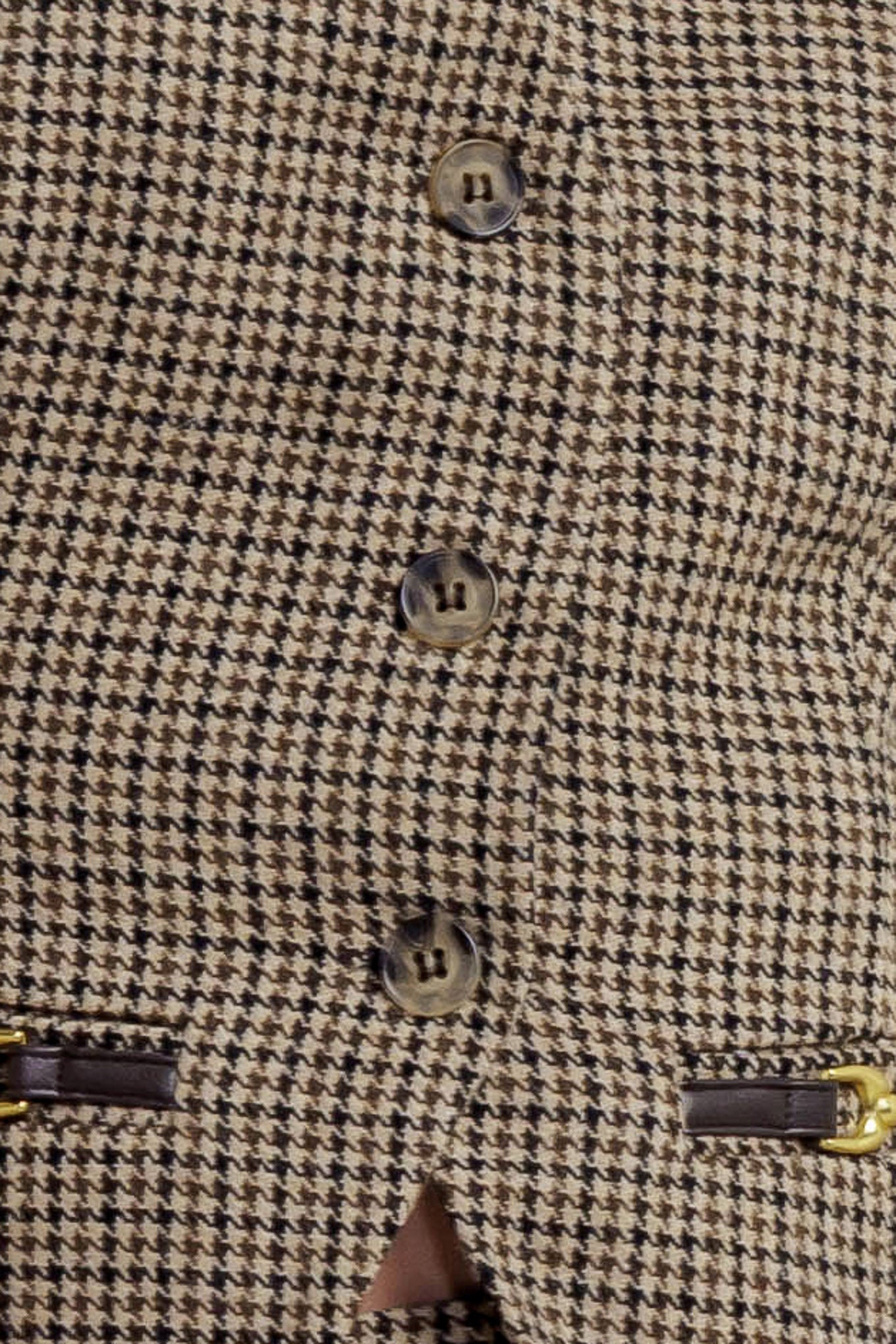 A woven woolen vest featuring V neckline, sleeveless, front button down and trim