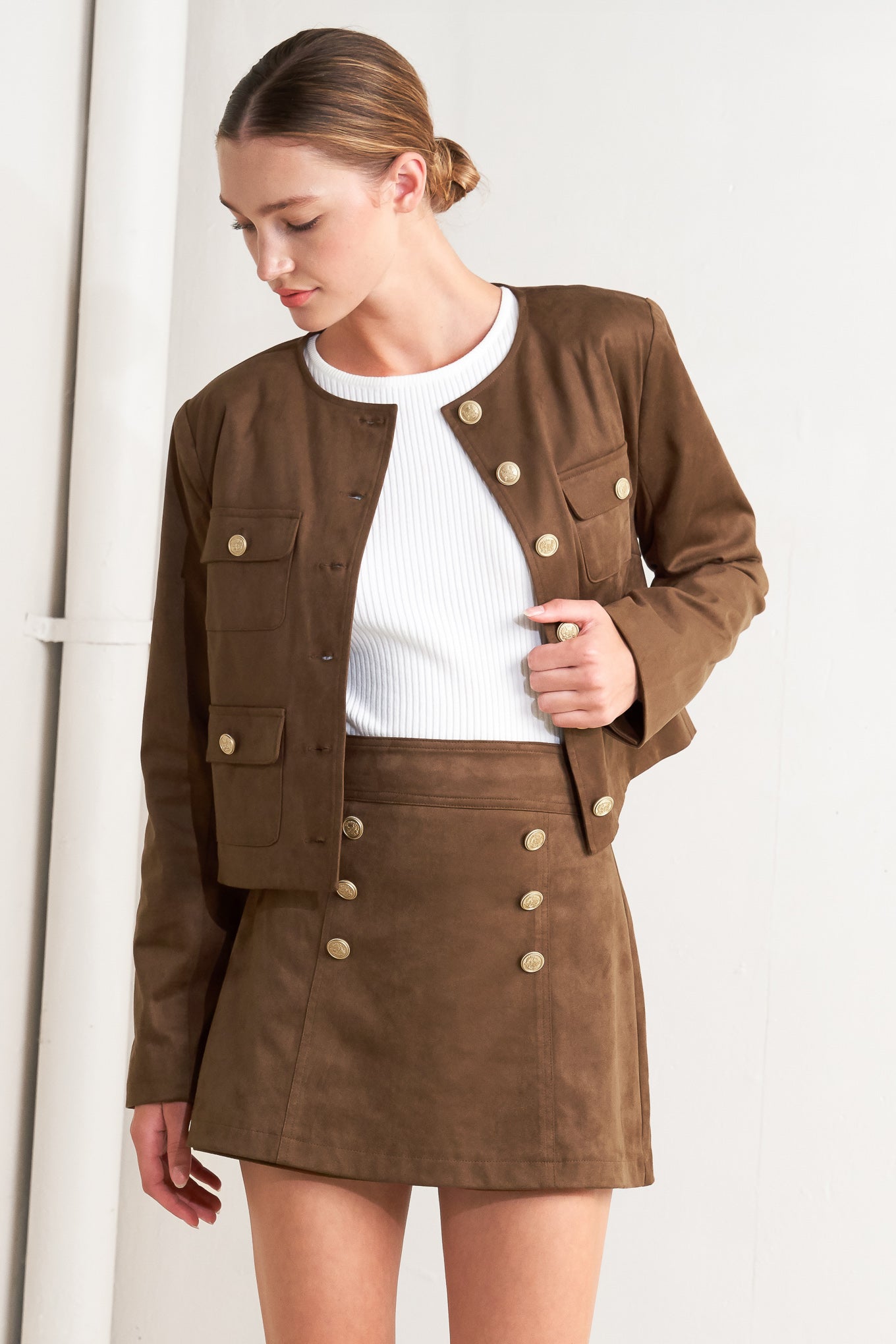 A faux suede cropped jacket featuring round neckline, long sleeve, front pockets and button down.&nbsp;