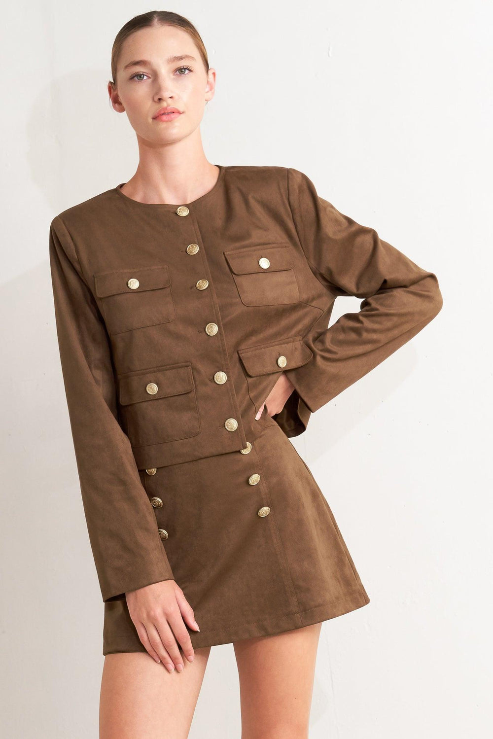 A faux suede cropped jacket featuring round neckline, long sleeve, front pockets and button down.&nbsp;