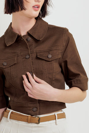 Woman wearing a brown short sleeve twill jacket with front button closure | FREEMARKET