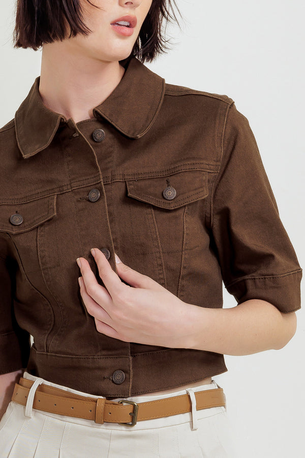 Woman wearing a brown short sleeve twill jacket with front button closure | FREEMARKET