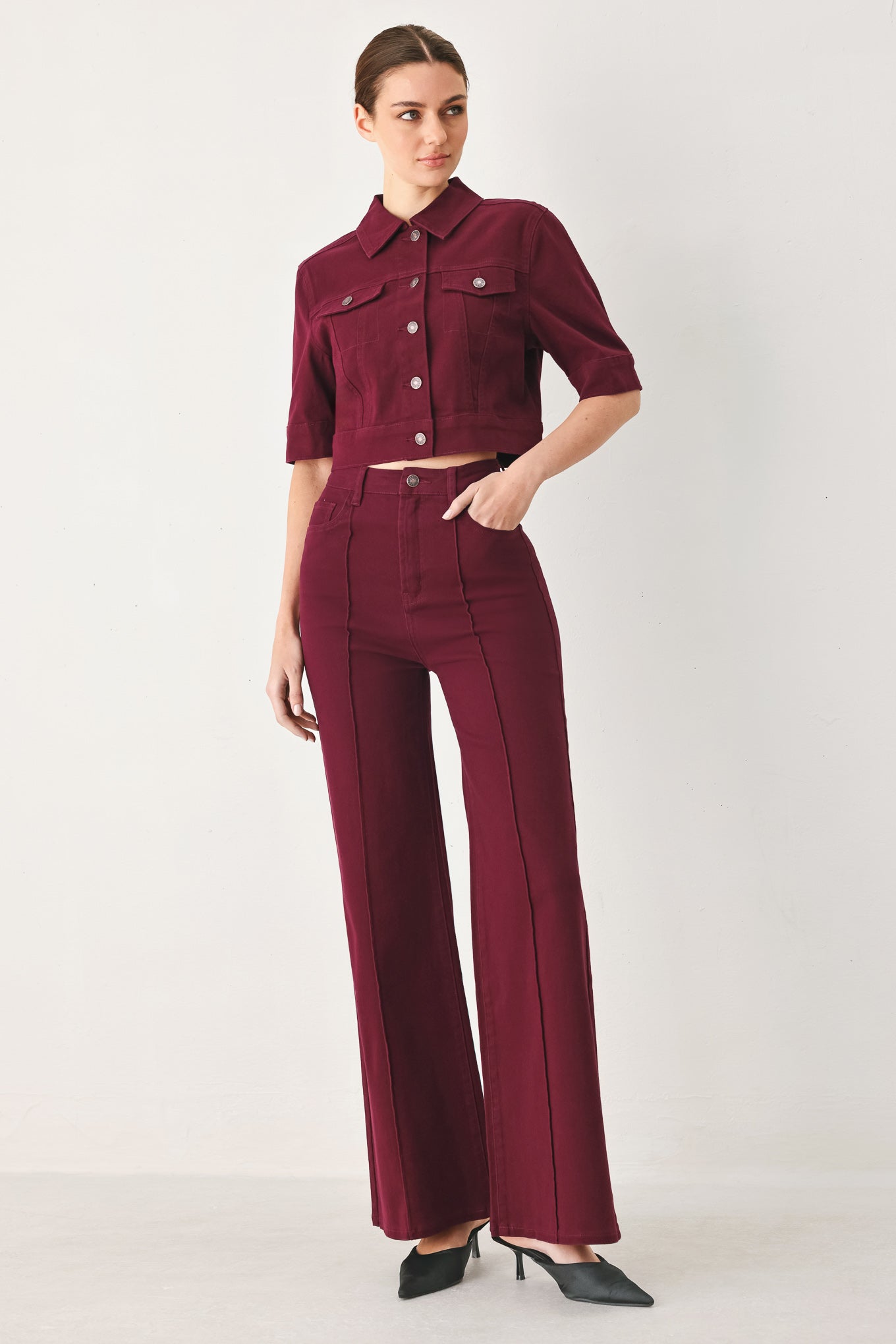 Woman wearing a burgundy short sleeve twill jacket with front button closure | FREEMARKET
