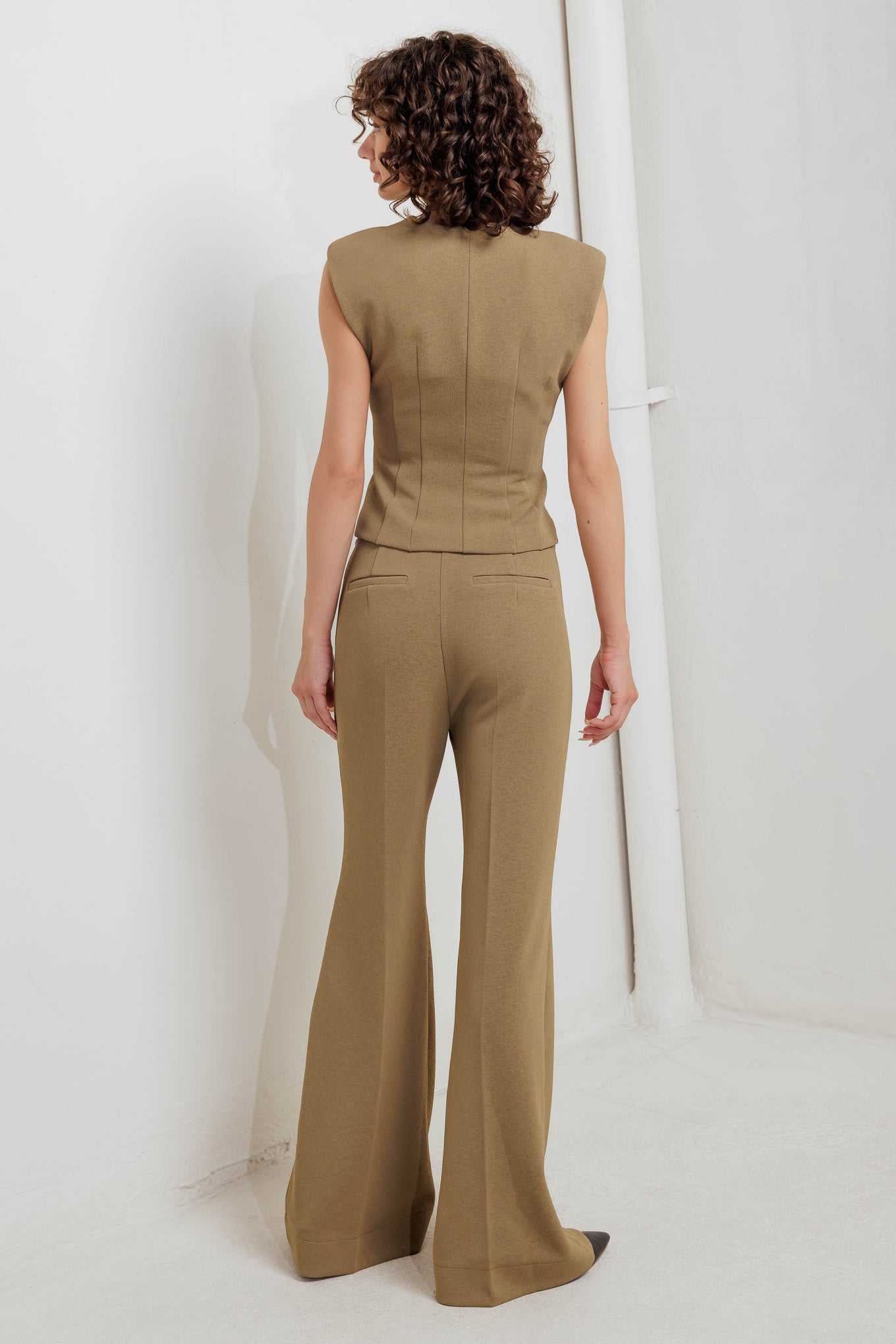 A solid woven vest with V neckline and front button closure. Matching pant FP1796