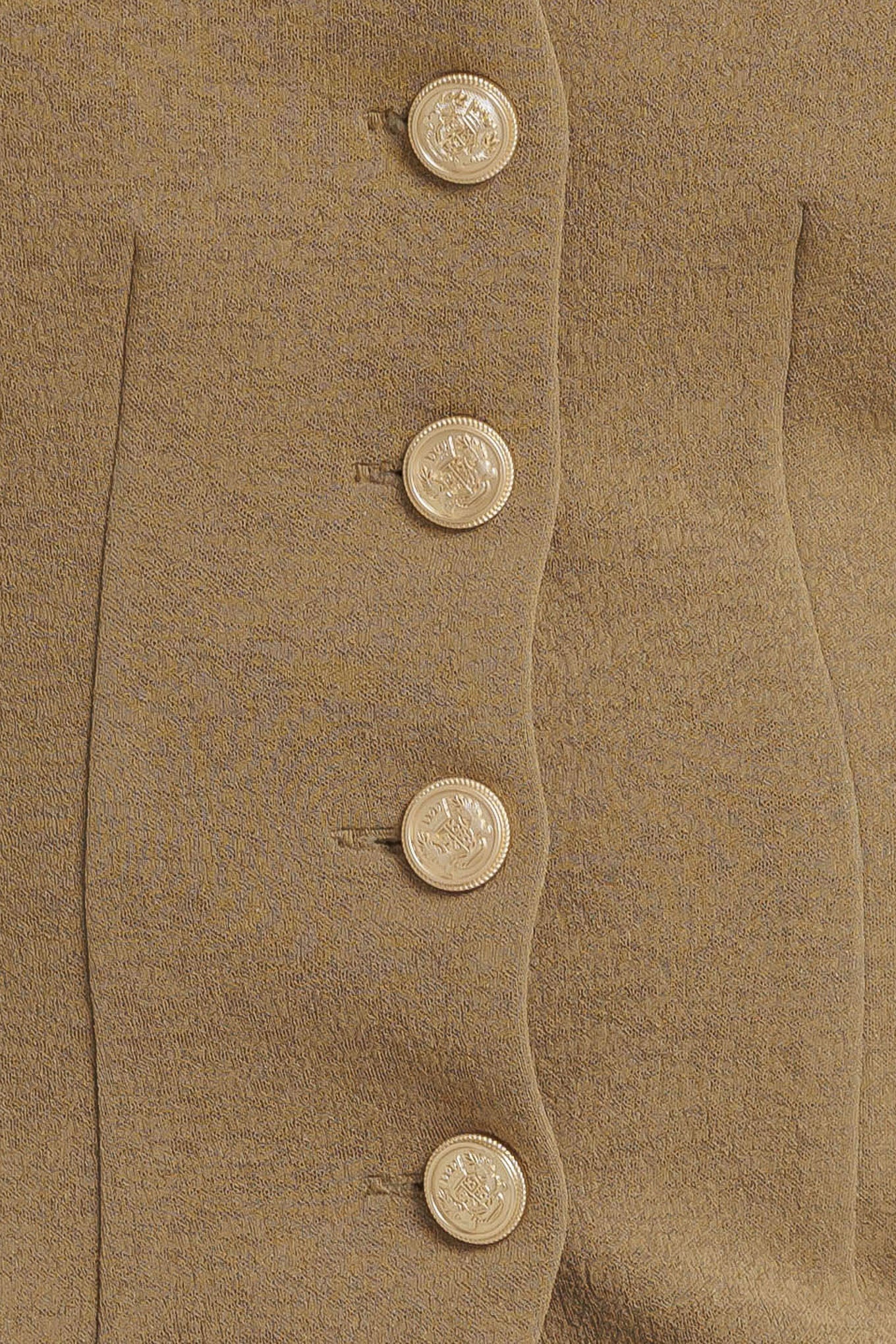 A solid woven vest with V neckline and front button closure