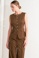 A faux suede vest featuring round neckline, sleeveless, front button closure and side pocket.