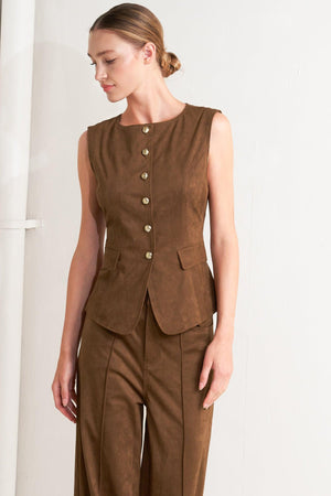 A faux suede vest featuring round neckline, sleeveless, front button closure and side pocket.