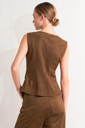 A faux suede vest featuring round neckline, sleeveless, front button closure and side pocket.