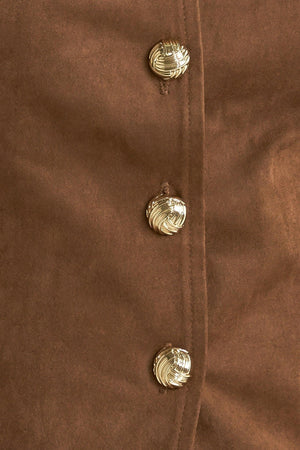 A faux suede vest featuring round neckline, sleeveless, front button closure and side pocket.