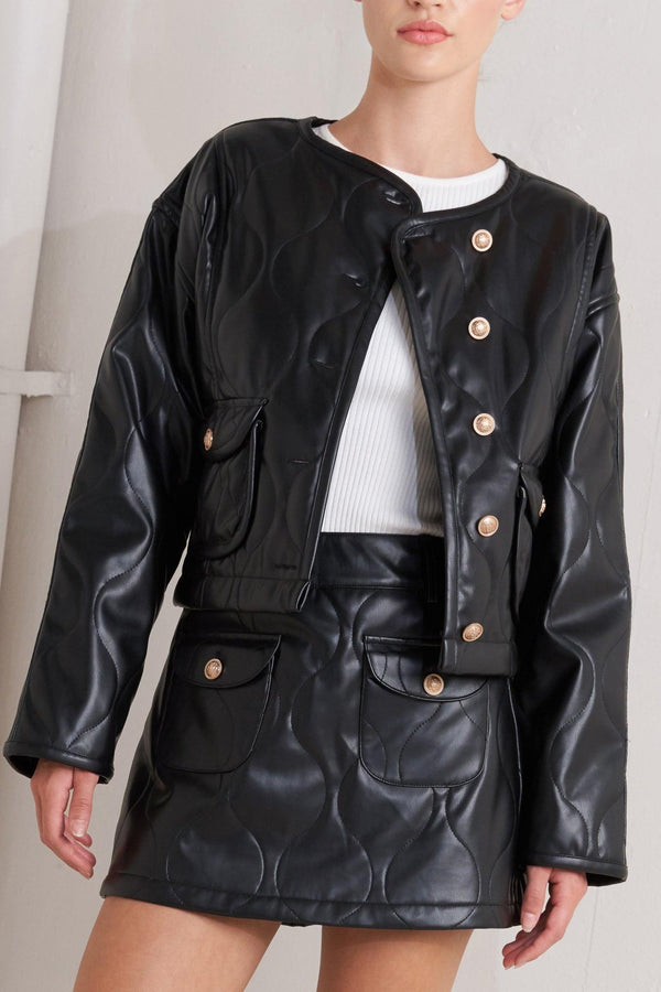 A quilted faux leather jacket with front pockets and button down closure.