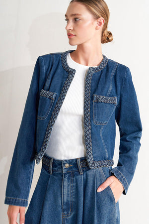 A washed denim jacket featuring round neckline, braided trim and hook &amp; eye closure