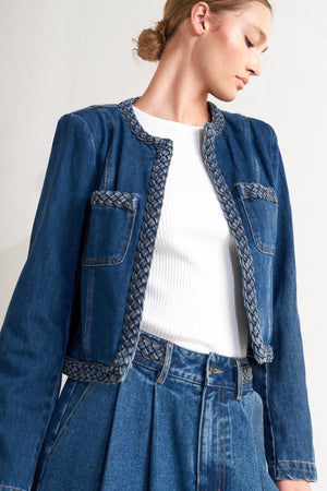 A washed denim jacket featuring round neckline, braided trim and hook &amp; eye closure