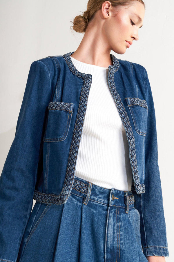 A washed denim jacket featuring round neckline, braided trim and hook &amp; eye closure
